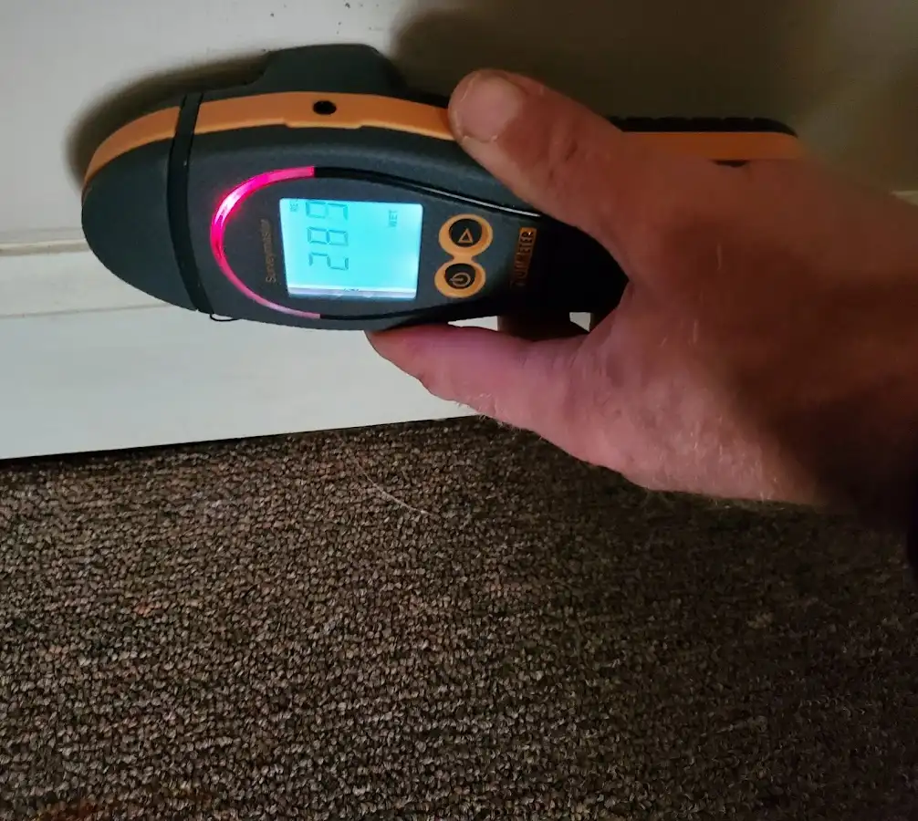 Moisture detection at baseboard during Storm Damage Restoration in Commerce